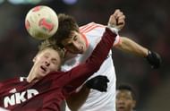 Bayern Munich's midfielder Javi Martinez (R) and Nuremberg's striker Sebastian Polter challenge for the ball
